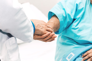 Doctor holding elderly person patient hand with care and consulting in hospital.healthcare and medicine