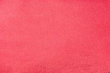 Background texture of red fleece. Plush velour closeup