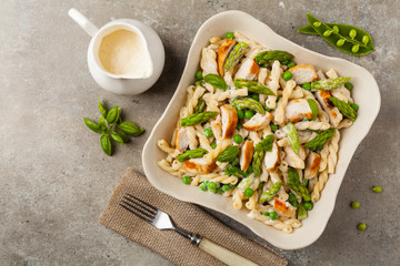 Italian pasta fusilli. Salad with chicken and asparagus in Béchamel sauce.