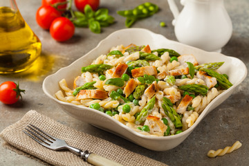 Italian pasta fusilli. Salad with chicken and asparagus in Béchamel sauce.