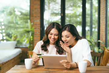 Two asian woman using laptop for shopping online with credit card payment