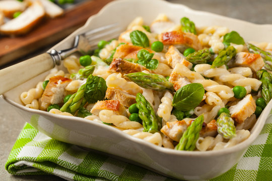 Italian pasta fusilli. Salad with chicken and asparagus in Béchamel sauce.