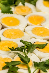 Boiled eggs cut in halves decorated with fresh parsley leaves