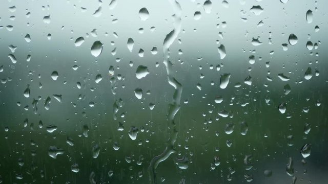 4K. rain running up on window surface. rain drop in rainy day
