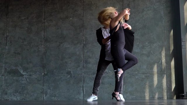 Beautiful couple of professional artists dancing passionate dance. slow-motion. Young couple dancing zouk dance