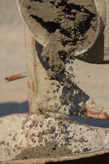 Construction site work with concrete mixer and wheelbarrows