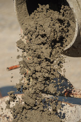 Construction site work with concrete mixer and wheelbarrows