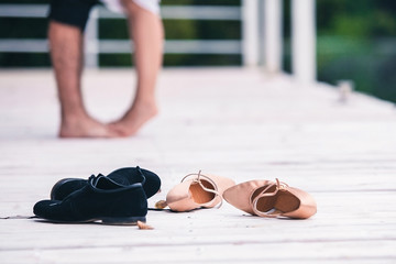 shoes for woman and man stand on the floor in the room on the background of a couple