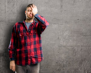 Young handsome man stressful keeping hand on head, tired and frustrated