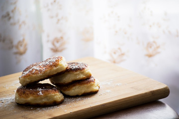 cheese curlers lie on a wooden board