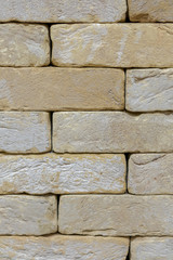 Wall of an old uneven light brick. background