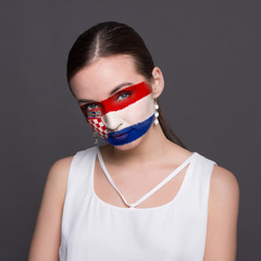 Young woman with Croatia flag painted on her face