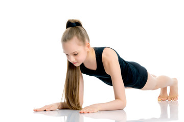 The gymnast perform an acrobatic element on the floor.