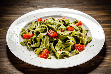 Pasta with vegetables on wooden table