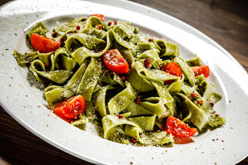 Pasta with vegetables on wooden table
