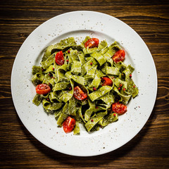 Pasta with vegetables on wooden table
