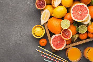 Variety of ripe citruses on gray background