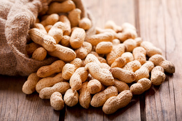 peanuts in a sack on wooden table