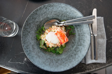 Russian salad with crab leg and poached egg