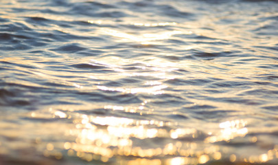 pebble stones on the sea beach, the rolling waves of the sea with foam