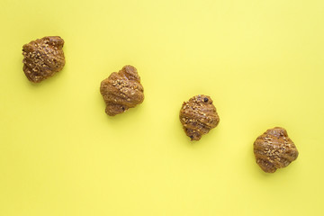 Croissant with almonds on yellow background