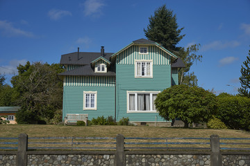 Historic wooden buildings lining the waterfront of Frutillar on the shore of Lake Llanquihue in the Lake District of southern Chile.