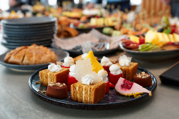 Desserts, fruits and other food on banquet table
