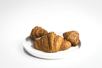 Croissant with almonds on white background