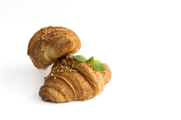Croissant with almonds on white background