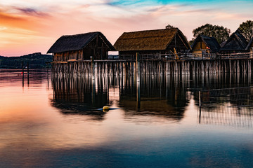 Colorfull sunset at Lake Dwellings of the Stone and Bronze Age in Unteruhldingen on Lake Constance,...