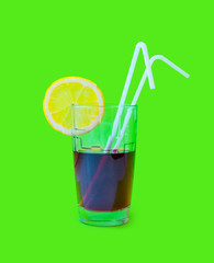 Fresh Juice glass with a straw slice of yellow lemon on a green background. Fashion pastel summer design style concept