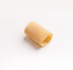 One raw paccheri on white background