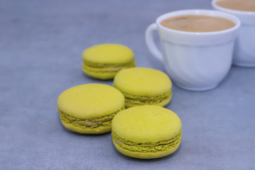 Macaroni cakes on a gray concrete background.