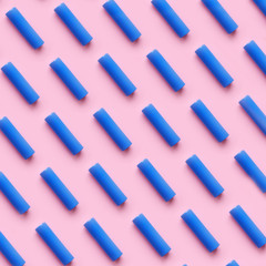 Fototapeta na wymiar blue battery pattern on a pink pastel background