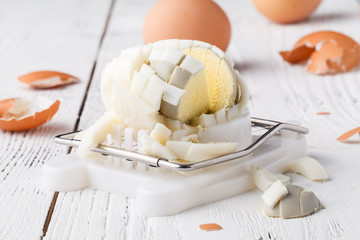 Fototapeta na wymiar Hard boiled egg sliced on egg cutter