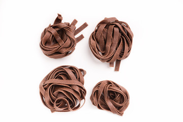Raw unprepared chocolate pasta noodles isolated