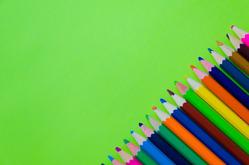 Fototapeta premium Set of colour pencils on green background 