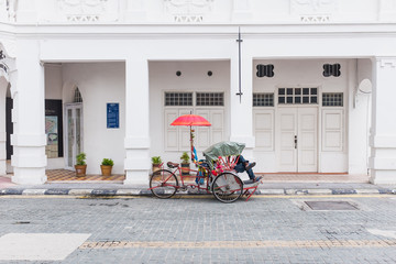 Tricycle parking infront of ancient building