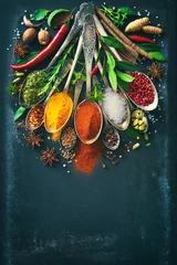 Keuken spatwand met foto Various herbs and spices on dark background © Alexander Raths