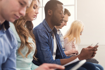 Group of business people using gadgets