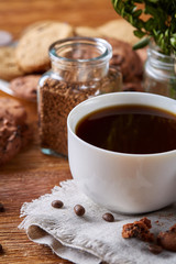 Breakfast background with mug of fresh coffee, homemade oatmeal cookies, grind coffee