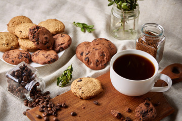 Breakfast background with mug of fresh coffee, homemade oatmeal cookies, grind coffee