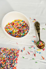 culinary sprinkling, cooking dressing in a Cup with a spoon on light background, close up