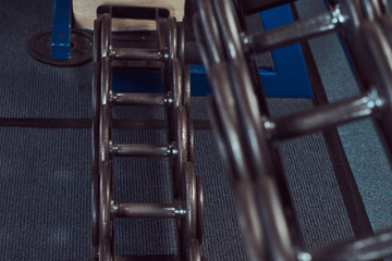 Black dumbbells on the counter in the gym