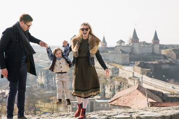 Fototapeta premium Happy family baby boy with mom and dad holiday