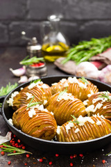 Baked potato. Potato oven baked with garlic and rosemary
