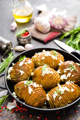 Baked potato. Potato oven baked with garlic and rosemary