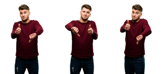 Handsome blond man confused with thumbs up and down, trying to take a decision expressing doubt and frustration isolated over white background