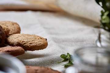 Breakfast background with mug of fresh coffee, homemade oatmeal cookies, grind coffee