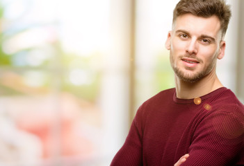 Fototapeta premium Handsome young man with crossed arms confident and happy with a big natural smile laughing